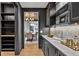 Chic bar area with marble countertop, dark cabinets, and open shelving, adjoining the dining area at 258 Pineland Nw Rd, Atlanta, GA 30342