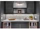Elegant bar area with marble countertop, mesh-door cabinets, and stylish lighting at 258 Pineland Nw Rd, Atlanta, GA 30342