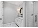 Bathroom featuring white cabinets, marble countertop, round mirror and a glass shower at 258 Pineland Nw Rd, Atlanta, GA 30342