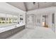 Luxurious bathroom featuring a large soaking tub, marble floors, and glass-enclosed shower at 258 Pineland Nw Rd, Atlanta, GA 30342