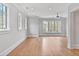 Sun-filled bedroom with hardwood floors, tray ceiling, and large windows with views of trees at 258 Pineland Nw Rd, Atlanta, GA 30342
