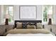 Bedroom with decorative pillows, bedside tables, and a white abstract art piece on the wall at 258 Pineland Nw Rd, Atlanta, GA 30342
