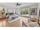 Bright bedroom with windows, light-colored walls, wood floor, and seating area at 258 Pineland Nw Rd, Atlanta, GA 30342