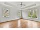 Spacious bedroom with hardwood floors, tray ceiling, and large windows offering natural light at 258 Pineland Nw Rd, Atlanta, GA 30342