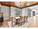 Elegant dining room boasts wood ceiling, stylish chandelier, and large window for ample natural light at 258 Pineland Nw Rd, Atlanta, GA 30342