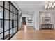 Inviting foyer with wood floors, modern lighting, artwork, and a staircase leading to upper levels at 258 Pineland Nw Rd, Atlanta, GA 30342