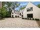 Side view of an elegant home featuring a brick driveway, symmetrical design, and a well-manicured lawn at 258 Pineland Nw Rd, Atlanta, GA 30342