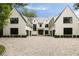 Elegant home featuring a brick driveway, symmetrical design, and a beautifully landscaped front yard at 258 Pineland Nw Rd, Atlanta, GA 30342