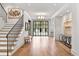 Bright foyer featuring hardwood floors, an elegant staircase, and a stylish console table at 258 Pineland Nw Rd, Atlanta, GA 30342