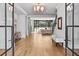 Spacious foyer with light hardwood floors, modern chandelier, and views of the living room and staircase at 258 Pineland Nw Rd, Atlanta, GA 30342