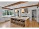 Spacious kitchen with a large island, marble countertops, and wood beam accents on the ceiling at 258 Pineland Nw Rd, Atlanta, GA 30342