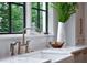 Close-up of kitchen sink showcasing marble countertops, stylish faucet, and a bright window with views at 258 Pineland Nw Rd, Atlanta, GA 30342