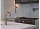 Modern kitchen design with marble backsplash, stainless steel range, and pot filler faucet at 258 Pineland Nw Rd, Atlanta, GA 30342