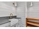 Well-lit laundry room featuring shiplap walls, farmhouse sink, and modern fixtures at 258 Pineland Nw Rd, Atlanta, GA 30342