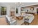 Inviting living room featuring a fireplace, comfortable furniture, and an open connection to the kitchen at 258 Pineland Nw Rd, Atlanta, GA 30342