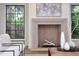 Living room with a fireplace and modern decor, offering a view of the greenery outside the window at 258 Pineland Nw Rd, Atlanta, GA 30342