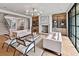 Open-concept living area with a fireplace, built-in shelves, and large windows offering ample natural light at 258 Pineland Nw Rd, Atlanta, GA 30342