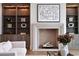 Cozy living room features a fireplace with herringbone brick, built-in shelves and modern decor at 258 Pineland Nw Rd, Atlanta, GA 30342