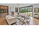 Beautiful living room featuring a fireplace, built-in shelving, and floor to ceiling windows at 258 Pineland Nw Rd, Atlanta, GA 30342