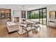 Bright living room featuring a fireplace, built-in shelves, modern furniture, and a large window at 258 Pineland Nw Rd, Atlanta, GA 30342