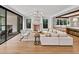 Bright, open-concept living room with modern furniture, a fireplace, and access to both kitchen and patio at 258 Pineland Nw Rd, Atlanta, GA 30342