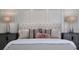 Tufted headboard, side tables, decorative pillows and lamps highlight the main bedroom design at 258 Pineland Nw Rd, Atlanta, GA 30342