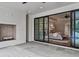 Inviting outdoor patio with a fireplace and glass sliding doors leading to the main bedroom and ensuite at 258 Pineland Nw Rd, Atlanta, GA 30342