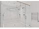 Modern shower with dual shower heads, seat, and intricate tile design, creating a spa-like experience at 258 Pineland Nw Rd, Atlanta, GA 30342
