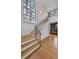 Elegant staircase with hardwood steps, black iron railing, and large windows for natural light at 258 Pineland Nw Rd, Atlanta, GA 30342