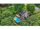 Aerial view of a home with a private pool, multiple decks, and mature trees at 2666 Peachtree Walk, Duluth, GA 30096