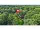 Aerial view of home nestled within a dense forest, showcasing its tranquil and private setting at 2666 Peachtree Walk, Duluth, GA 30096