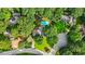 Stunning aerial view of a home with a private pool surrounded by lush trees and landscaping at 2666 Peachtree Walk, Duluth, GA 30096