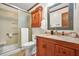 Bathroom with granite countertop, tile shower, and built in storage at 2666 Peachtree Walk, Duluth, GA 30096
