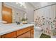 Bathroom with updated vanity, floral shower curtain, and modern fixtures at 2666 Peachtree Walk, Duluth, GA 30096