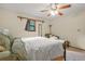 Bedroom featuring a bed, vintage chaise lounge, natural light, and neutral decor at 2666 Peachtree Walk, Duluth, GA 30096