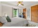 Bright bedroom featuring a ceiling fan, natural light from the window, and neutral decor at 2666 Peachtree Walk, Duluth, GA 30096