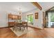 Sunlit dining room with hardwood floors, beam ceilings, and mid-century modern design elements at 2666 Peachtree Walk, Duluth, GA 30096