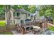 Exterior of home with multiple decks, patios, fenced yard and lush trees at 2666 Peachtree Walk, Duluth, GA 30096