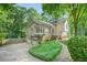 Charming multi-level home with a bay window, attached two-car garage, and lush landscaping at 2666 Peachtree Walk, Duluth, GA 30096