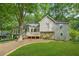 Attractive two-story home with stone accents, a front porch, and mature trees at 2666 Peachtree Walk, Duluth, GA 30096