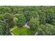 Exterior view of a home surrounded by lush trees, featuring a well-manicured lawn and driveway at 2666 Peachtree Walk, Duluth, GA 30096
