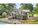 Rear exterior of home features two decks, patio, fenced yard and inground pool at 2666 Peachtree Walk, Duluth, GA 30096