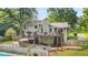 Rear exterior of home features two decks, patio, fenced yard and inground pool at 2666 Peachtree Walk, Duluth, GA 30096