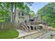 Exterior home view with decks, patios, and green lawn at 2666 Peachtree Walk, Duluth, GA 30096