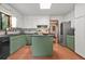 Spacious kitchen with sage green cabinets, stainless steel appliances, and a center island at 2666 Peachtree Walk, Duluth, GA 30096