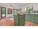 Kitchen with sage green cabinets, a center island, and lots of natural light at 2666 Peachtree Walk, Duluth, GA 30096