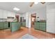 Charming kitchen featuring sage green cabinets, a center island, and stainless steel appliances at 2666 Peachtree Walk, Duluth, GA 30096
