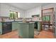 Charming kitchen featuring stylish sage green cabinets and center island with seating at 2666 Peachtree Walk, Duluth, GA 30096