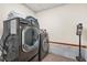 Laundry room featuring front loading washer and dryer with storage at 2666 Peachtree Walk, Duluth, GA 30096