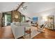 Bright living room showcasing a stone fireplace, high ceilings, wood beams, and hardwood floors at 2666 Peachtree Walk, Duluth, GA 30096